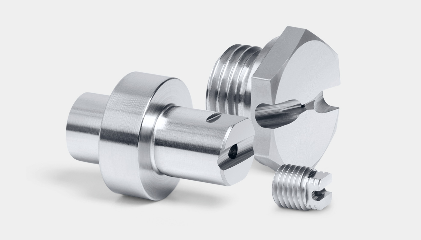 Three SCHMIDT EHS flat spray nozzles: a flat spray plug-in nozzle (model FS 300), a flat spray screw-in nozzle (model FS-G 140) and a flat spray nozzle exit unit (model ME-F 04).